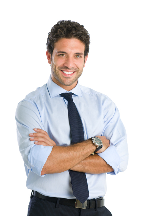 Businessman smiling, standing with arms folded