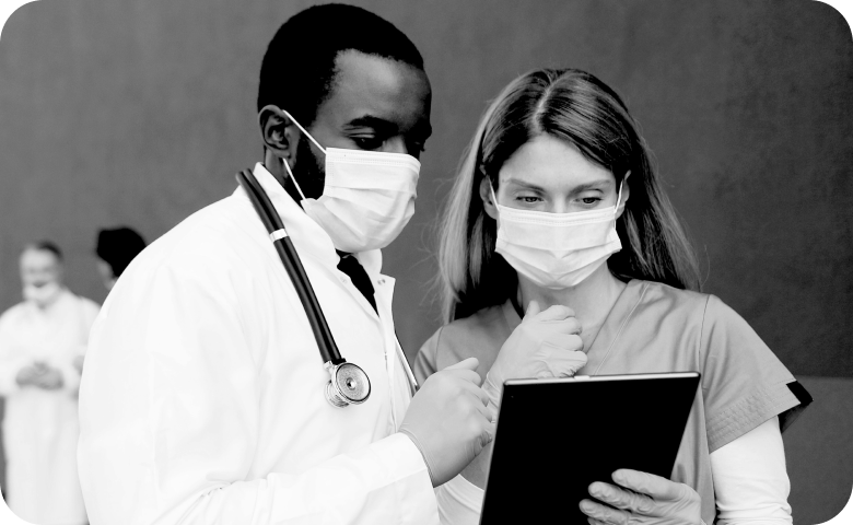 an image of two healthcare personnel reviewing resources